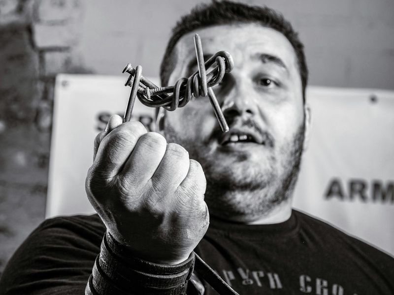 Close up of a man hands gripping a barbell with focus
